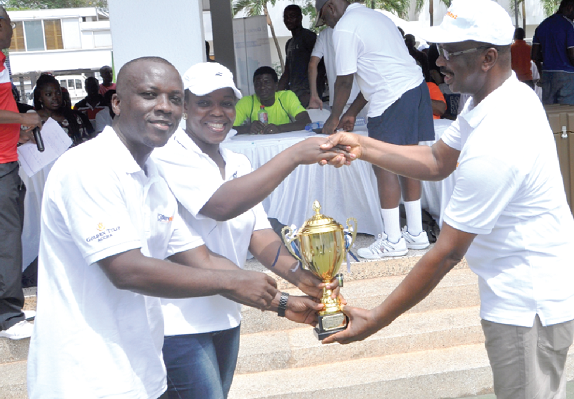 Deputy General Manager of Golden Tulip Hotel, Mr Francis Deyegbe (right) hands over the champions’ trophy to the VRA Team